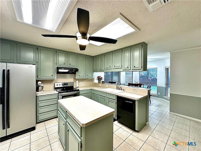 209 Westbrook Dr, Victoria, TX 77904 - kitchen featuring green cabinets, stainless steel appliances, under cabinet range hood, light countertops, and light tile patterned floors