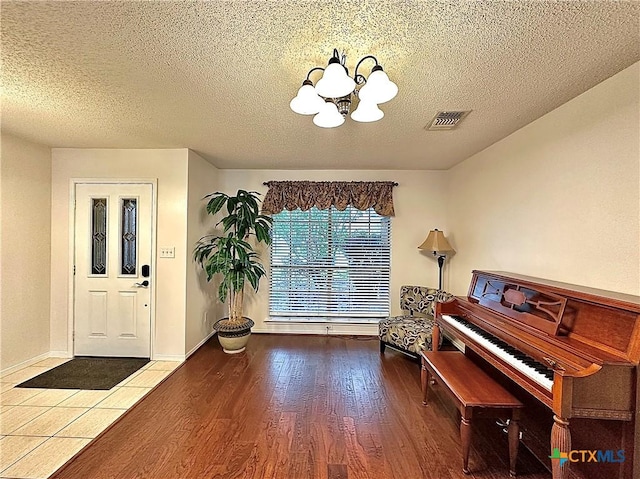209 Westbrook Dr, Victoria, TX 77904 - living area with a chandelier, wood finished floors, and a textured ceiling