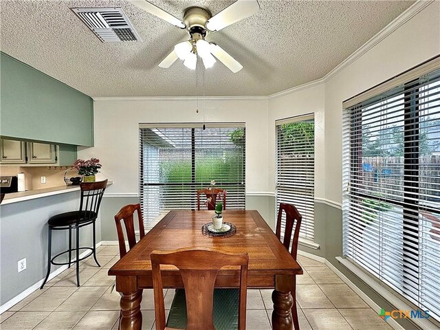 209 Westbrook Dr, Victoria, TX 77904 - dining room with light tile patterned floors, a textured ceiling, plenty of natural light, a ceiling fan, and ornamental molding