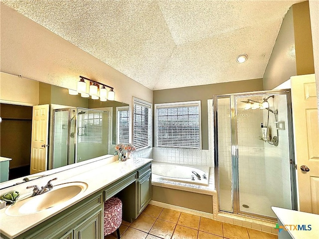 209 Westbrook Dr, Victoria, TX 77904 - bathroom featuring lofted ceiling, a textured ceiling, a bath, vanity, and a shower stall