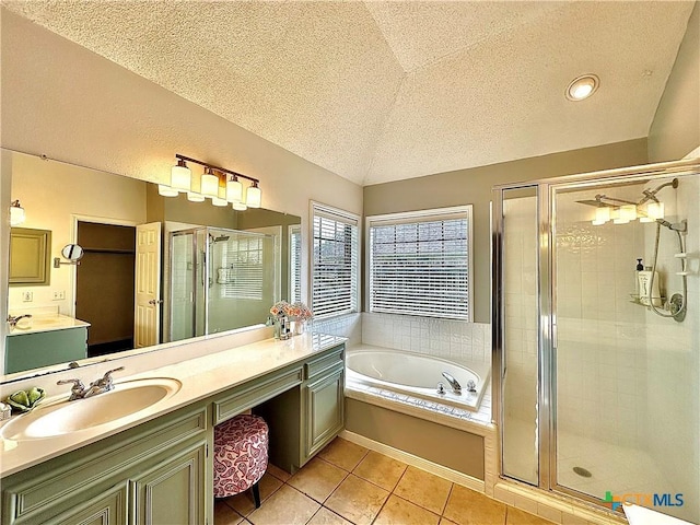209 Westbrook Dr, Victoria, TX 77904 - full bathroom featuring a shower stall, a textured ceiling, vanity, a bath, and tile patterned floors