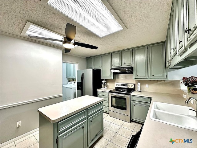 209 Westbrook Dr, Victoria, TX 77904 - kitchen featuring appliances with stainless steel finishes, washer and clothes dryer, green cabinets, light tile patterned floors, and under cabinet range hood