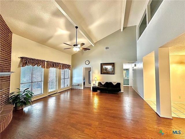 209 Westbrook Dr, Victoria, TX 77904 - living room with ceiling fan, wood finished floors, beam ceiling, high vaulted ceiling, and a fireplace