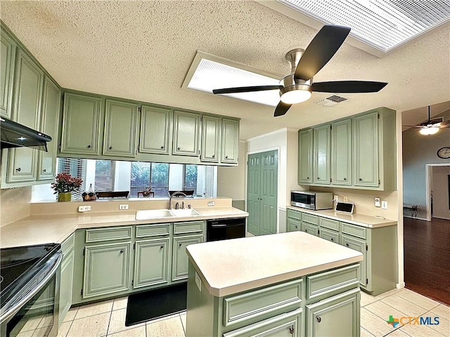 209 Westbrook Dr, Victoria, TX 77904 - kitchen with green cabinetry, stainless steel appliances, ceiling fan, light countertops, and a textured ceiling
