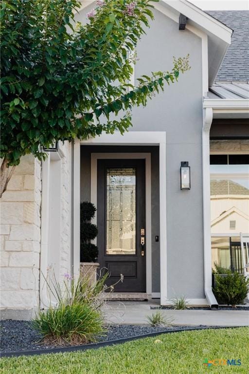 110 Terra Vista Ranch Rd, Victoria, TX 77904 - doorway to property featuring a standing seam roof, a metal roof, and stucco siding