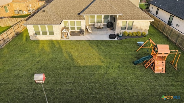110 Terra Vista Ranch Rd, Victoria, TX 77904 - rear view of house with a patio area, roof with shingles, brick siding, a fenced backyard, and a playground