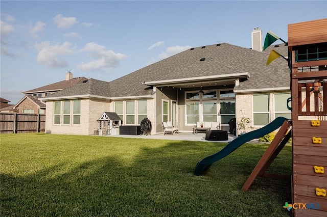110 Terra Vista Ranch Rd, Victoria, TX 77904 - back of house with brick siding, a fenced backyard, a playground, a patio, and a shingled roof