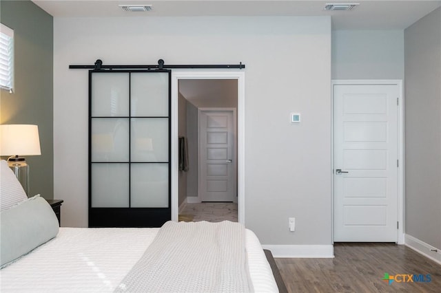 110 Terra Vista Ranch Rd, Victoria, TX 77904 - bedroom with wood finished floors and a barn door