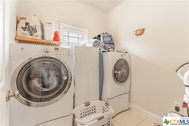 1402 Summer Glen Dr, Harker Heights, TX 76548 - laundry room featuring light tile patterned floors, washing machine and clothes dryer, and baseboards