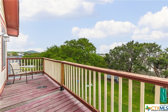 wooden deck with a lawn