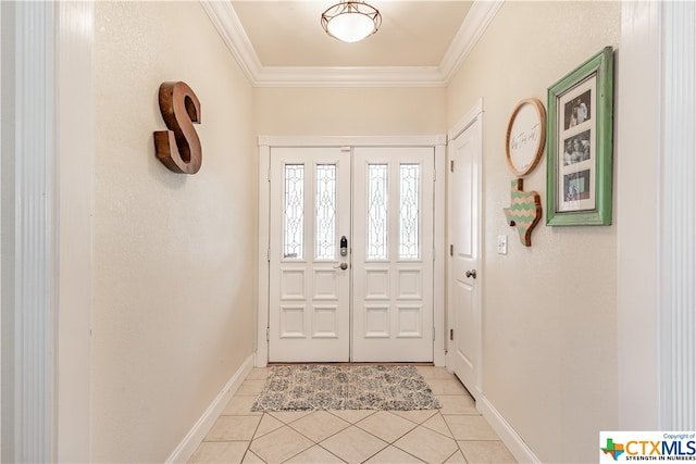 tiled entryway featuring crown molding