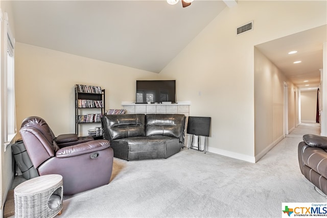 living room with light carpet and vaulted ceiling