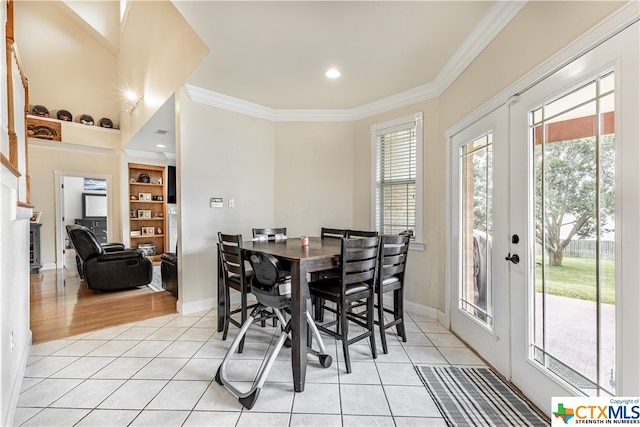 tiled dining area featuring french doors and ornamental molding