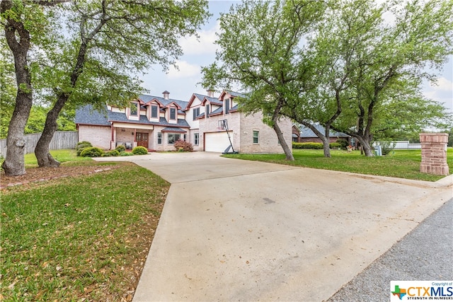 view of front facade with a garage and a front lawn