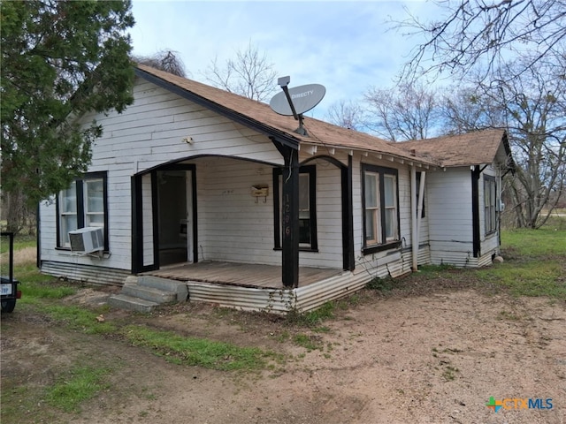 view of front of house with cooling unit and covered porch