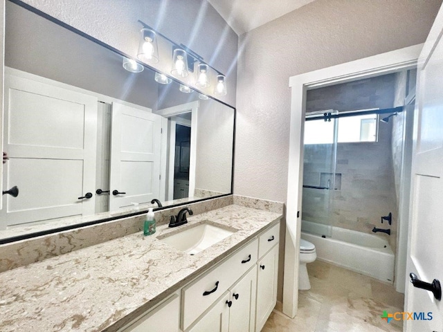 full bathroom featuring tiled shower / bath, vanity, and toilet