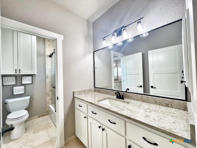 full bathroom with tiled shower / bath, vanity, and toilet