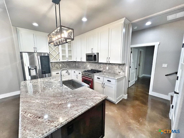 kitchen featuring white cabinetry, sink, pendant lighting, and appliances with stainless steel finishes