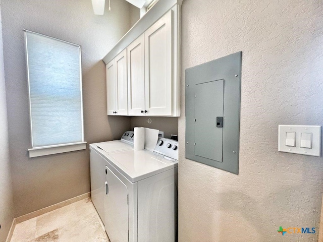 clothes washing area with electric panel, washing machine and dryer, and cabinets