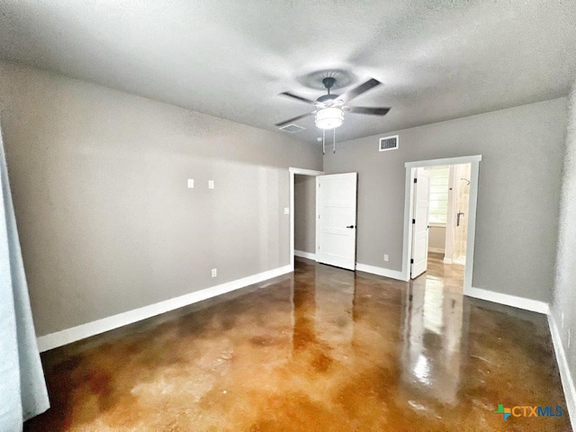 unfurnished bedroom with ceiling fan and a textured ceiling