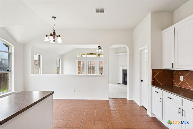 2010 Schorn Dr, Killeen, TX 76542 - kitchen with dark countertops, white cabinets, backsplash, pendant lighting, and lofted ceiling