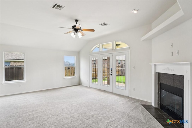 2010 Schorn Dr, Killeen, TX 76542 - unfurnished living room featuring a tiled fireplace, carpet floors, a ceiling fan, vaulted ceiling, and french doors