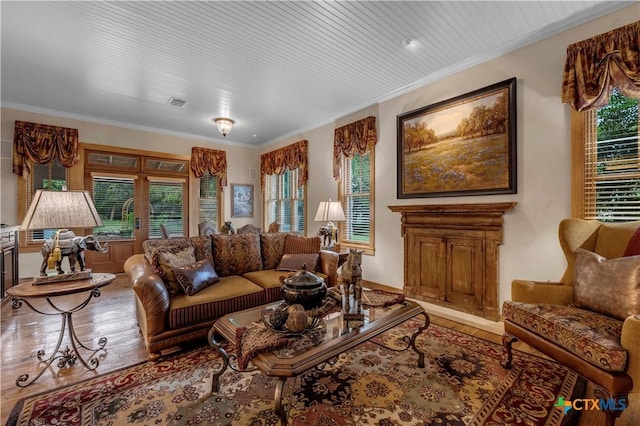 living room with plenty of natural light, hardwood / wood-style floors, and ornamental molding