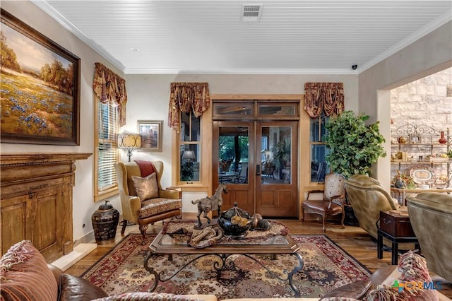 living area featuring french doors, light hardwood / wood-style floors, and ornamental molding