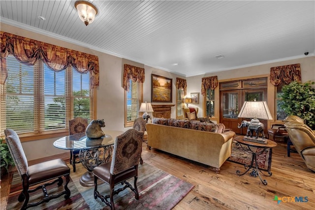 living room with crown molding and light hardwood / wood-style flooring