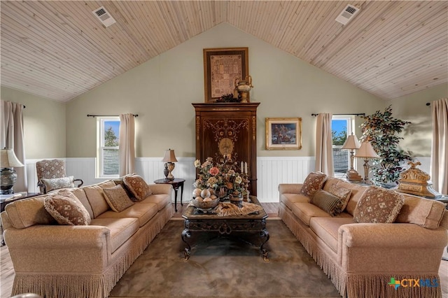 living room with wooden ceiling and high vaulted ceiling