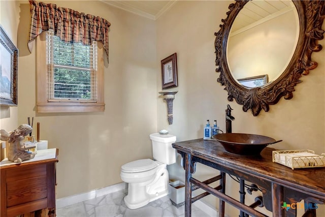 bathroom featuring crown molding, vanity, and toilet