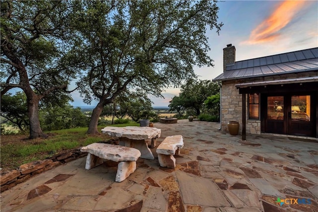 patio terrace at dusk featuring french doors