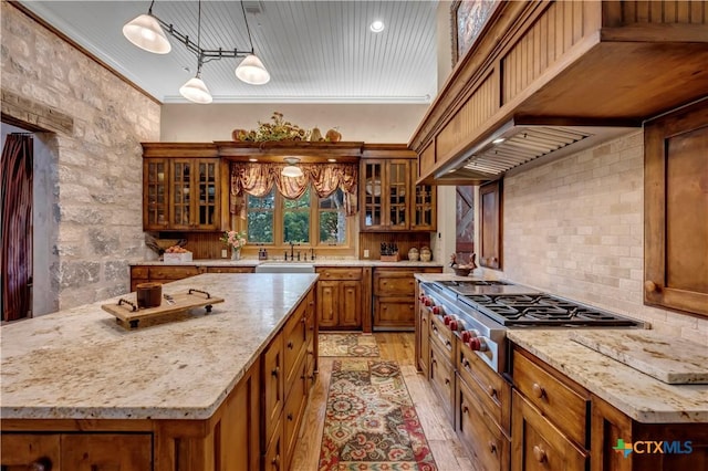 kitchen featuring a center island, light hardwood / wood-style floors, and hanging light fixtures