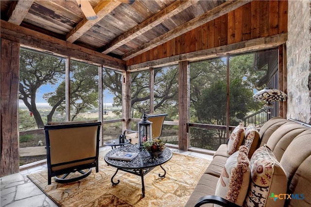 sunroom / solarium featuring lofted ceiling with beams and wooden ceiling