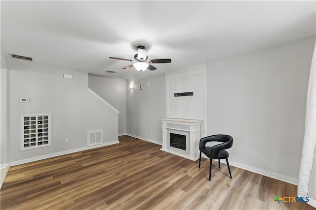 326 Trestle Tree, San Marcos, TX 78666 - unfurnished living room featuring wood finished floors, ceiling fan, baseboards, and a fireplace