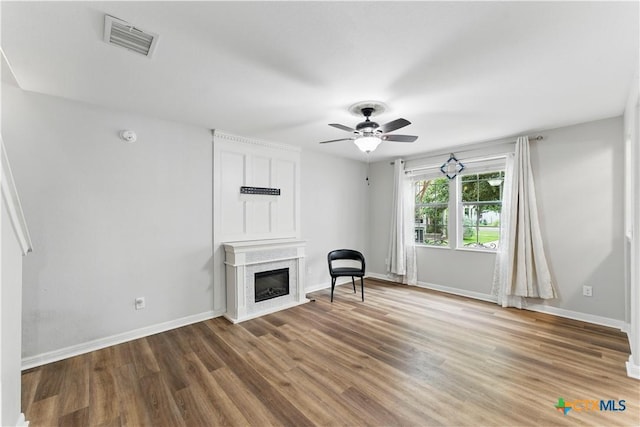 326 Trestle Tree, San Marcos, TX 78666 - unfurnished room with ceiling fan, wood finished floors, baseboards, and a glass covered fireplace