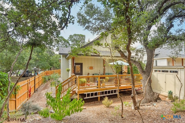 back of house with a wooden deck