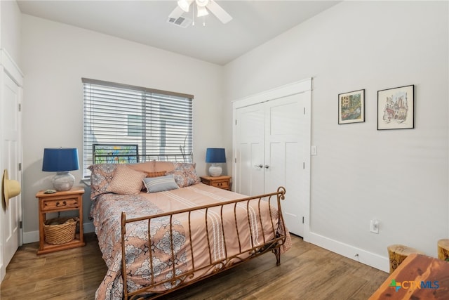 bedroom with ceiling fan, dark hardwood / wood-style floors, and a closet