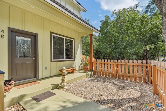 view of exterior entry with a patio