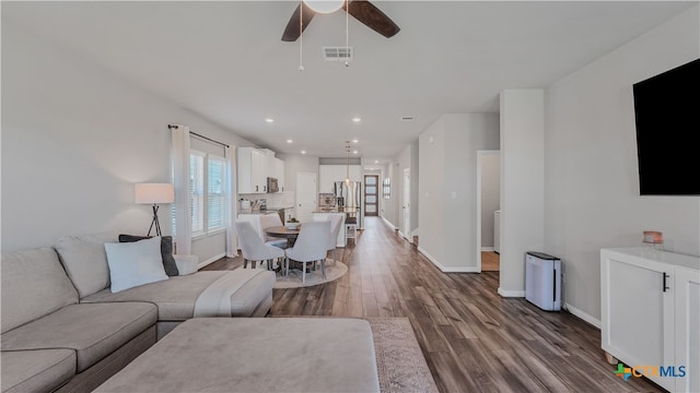 living room with hardwood / wood-style floors and ceiling fan