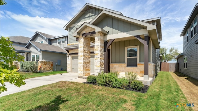 craftsman-style home featuring a front lawn and a garage