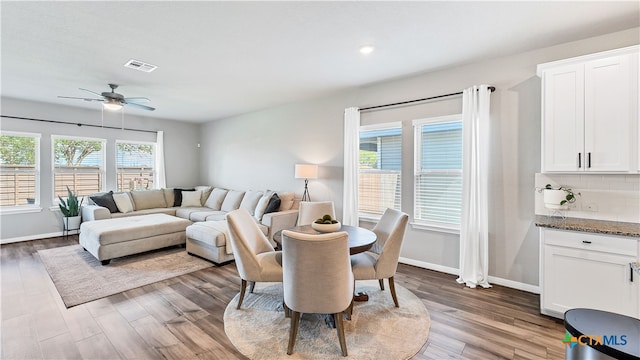 dining room featuring wood-type flooring and ceiling fan