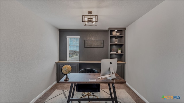 office space with light colored carpet and a textured ceiling