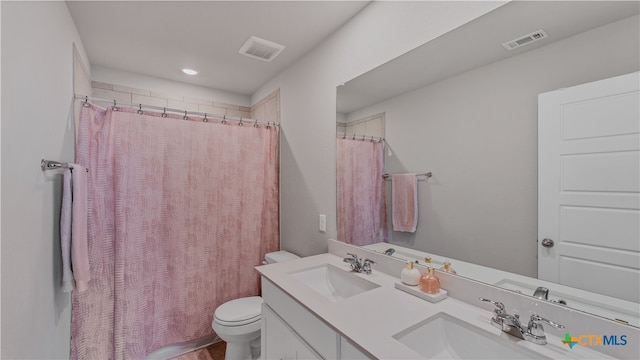 bathroom featuring toilet, a shower with curtain, and vanity