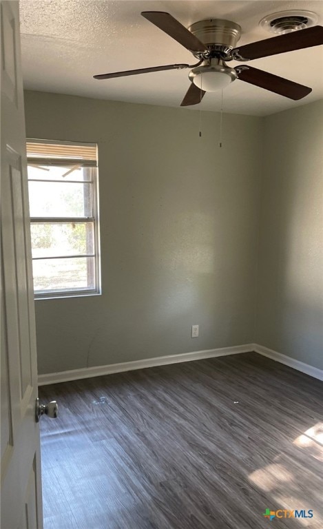 spare room with ceiling fan and dark hardwood / wood-style floors