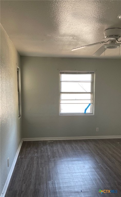 spare room featuring ceiling fan, dark hardwood / wood-style flooring, and a textured ceiling