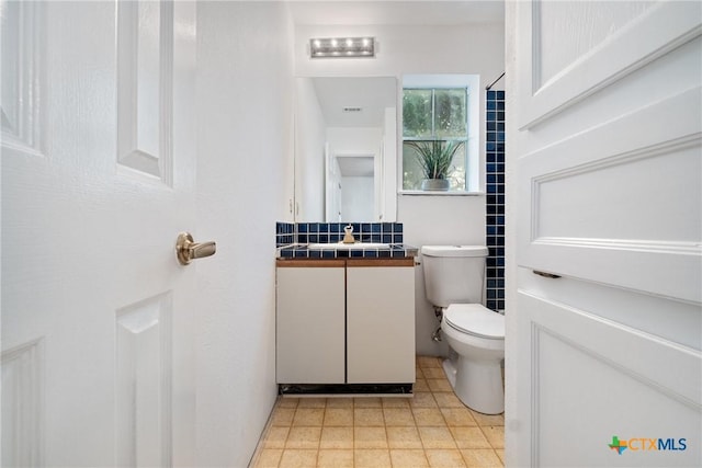 half bath featuring toilet and vanity