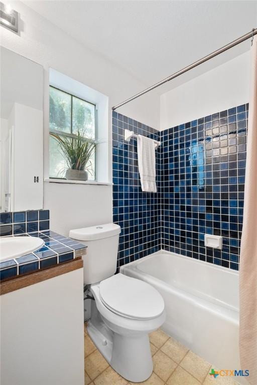 bathroom with vanity, tile patterned flooring, shower / tub combination, and toilet