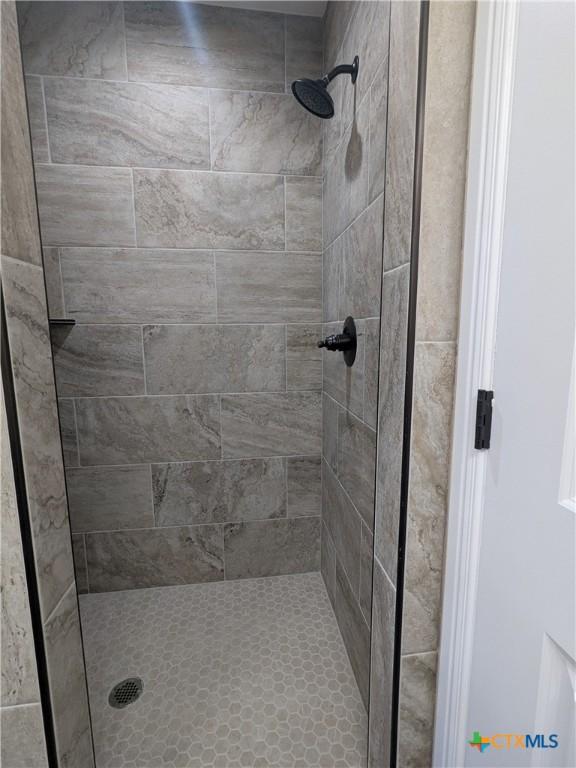 bathroom with tiled shower