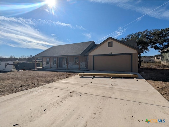 ranch-style house with a garage and a porch